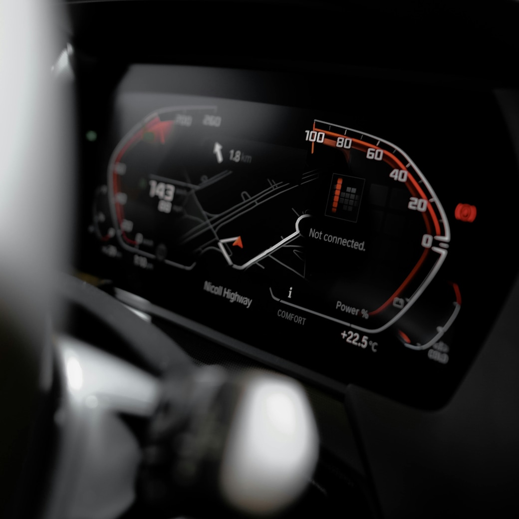 Close-up of a modern car instrument panel with digital gauges and navigation display
