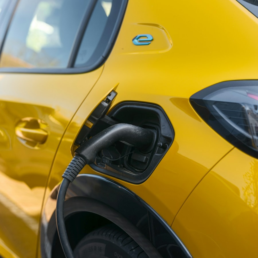 Electric vehicle charging in an outdoor close-up of the front end and connector