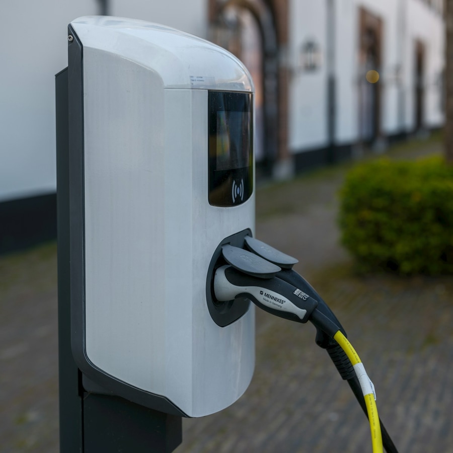 EV charging station with plug connected in a close-up of hardware and cable
